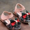 Pink infant sandals with bows, stylish and festive for babies