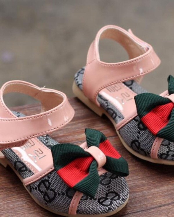 Pink infant sandals with bows, stylish and festive for babies