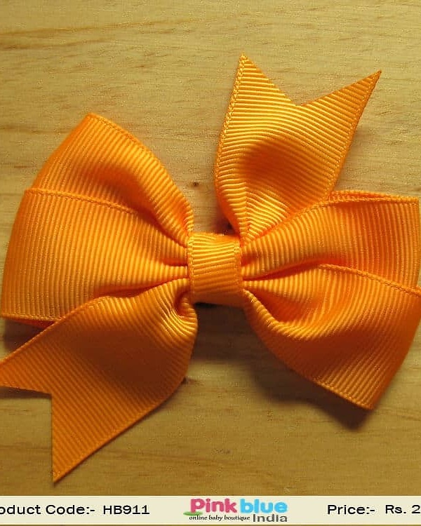 Orange bow infant hairband for festive outfit, vibrant stylish look